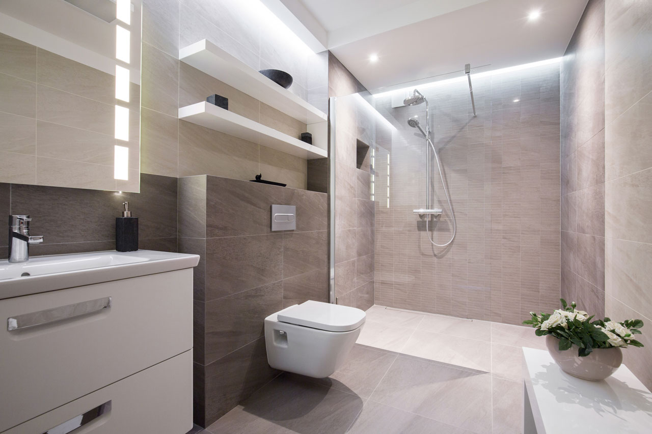 A chic bathroom design featuring a freestanding tub, glass-enclosed shower, and a striking black and white patterned floor.